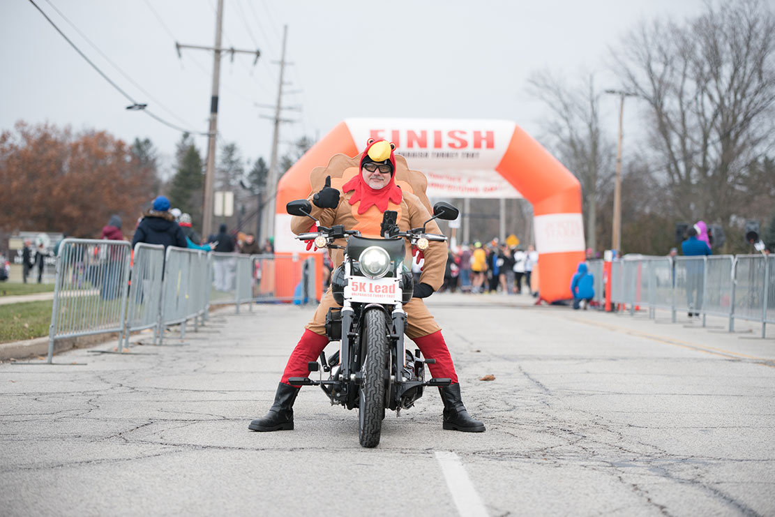 A Valpo Turkey Trot volunteer leads the race dressed as a turkey.